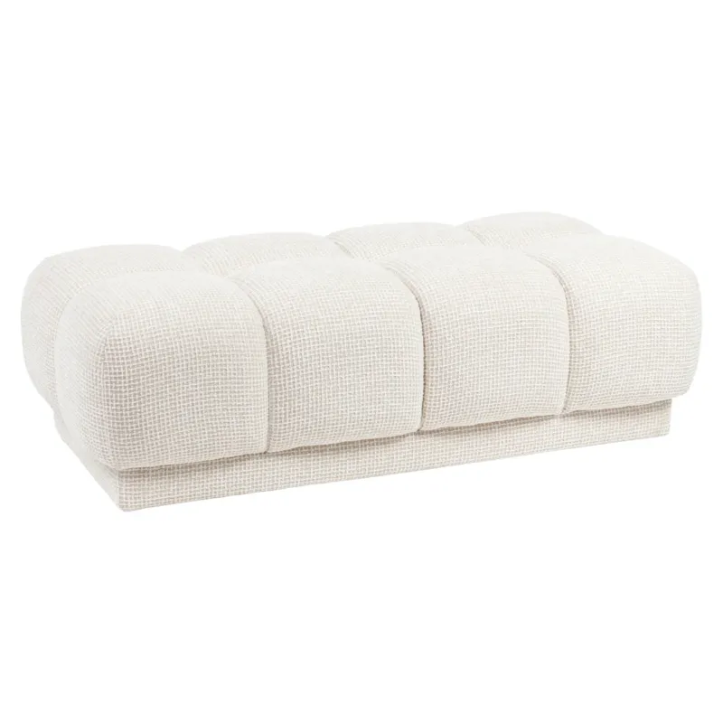 Hocker & Fußbank Noah beige Blockweave mit vier abgerundeten, gepolsterten Segmenten.