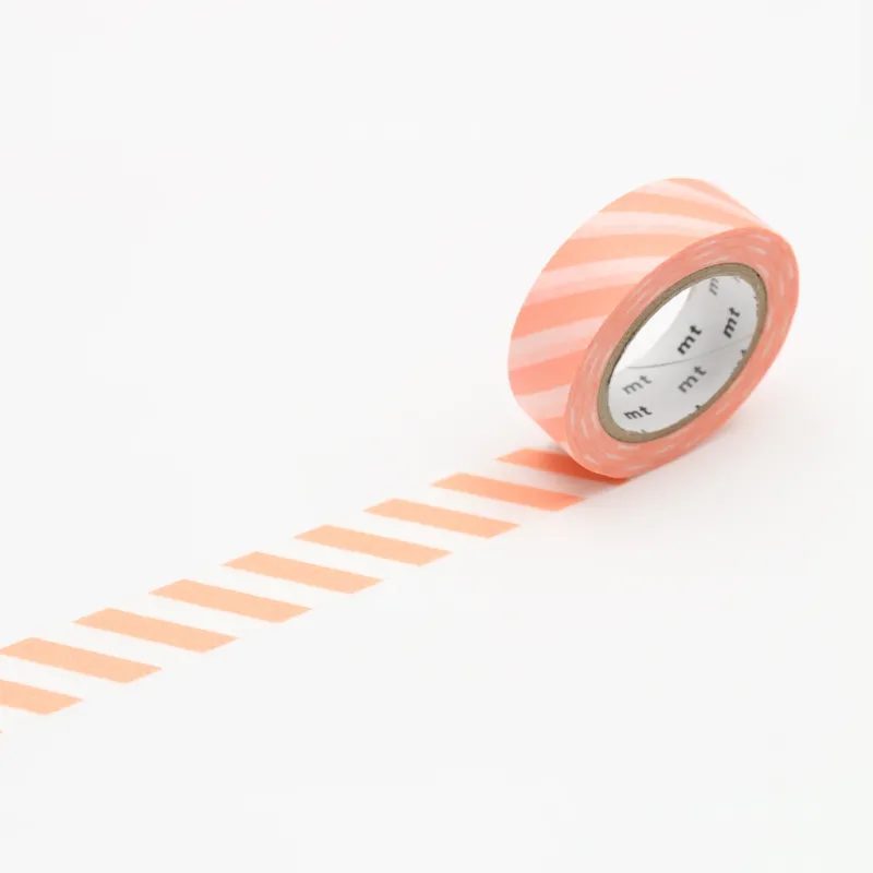 A roll of MT masking tape with a pattern of stripes in varying shades of white and orange, unrolled slightly to show the pattern.